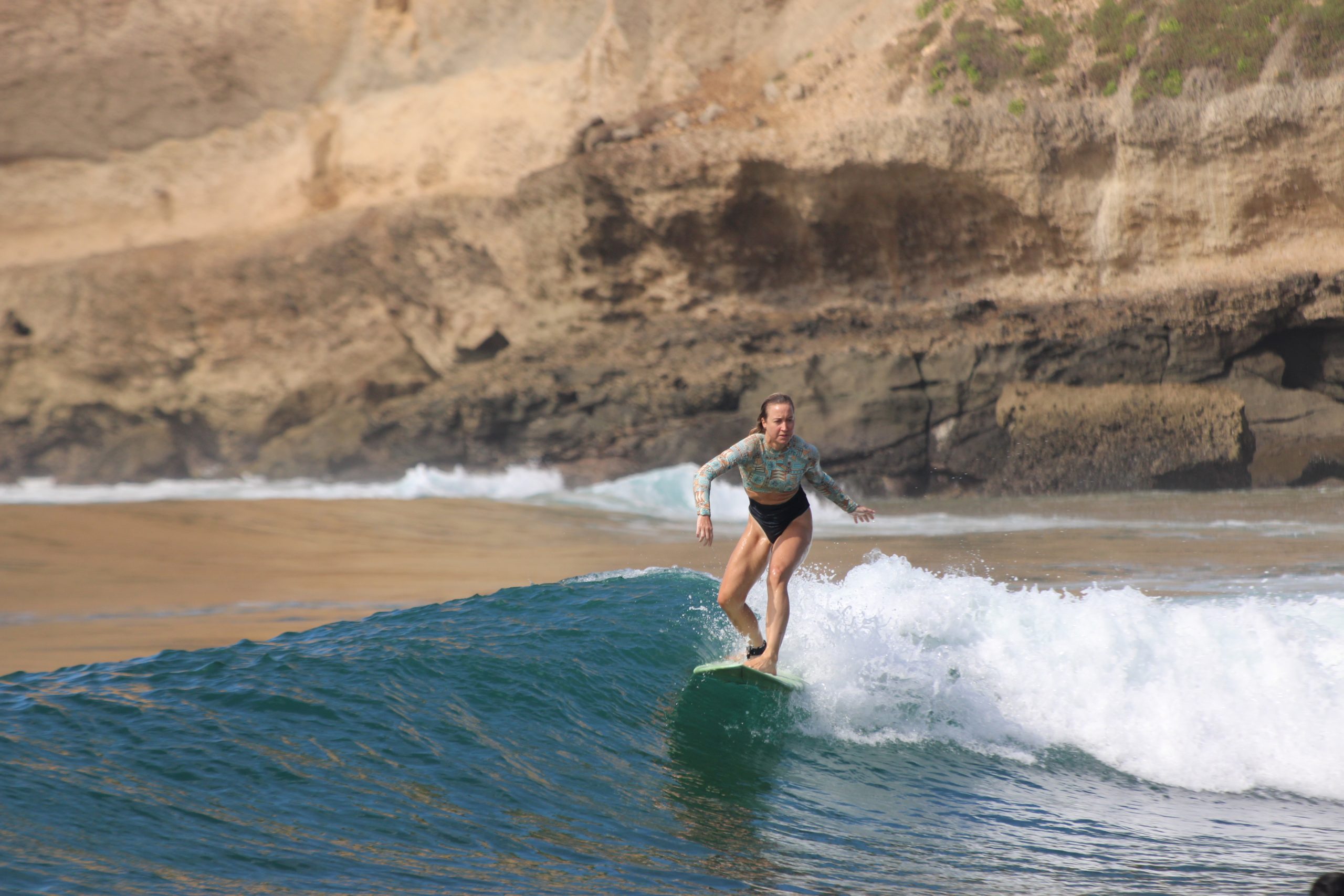 surfer catching a wave during a surf trip in Lombok